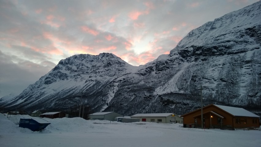 The sunrise that is south of us showing up on above the mountains of the fjord at Birtavarre