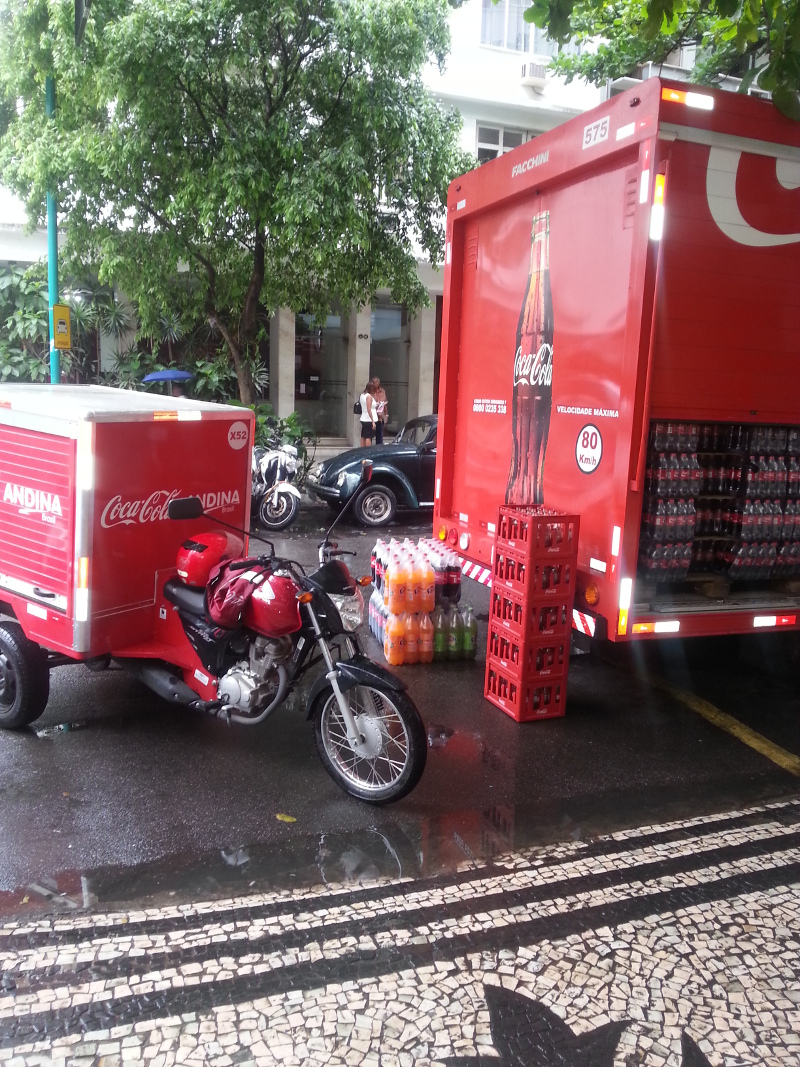 Coke truck unloading to a little Coke delivery bike. There is not much room in the streets for large trucks