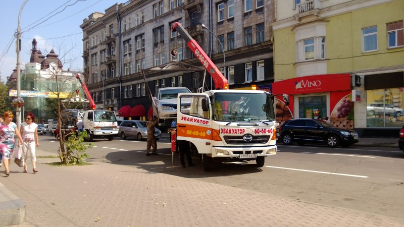 Tow trucks removing illegally parked cars
