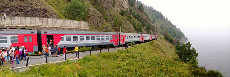 the Circum Baikal tourist train, electric train pulled by a diesel-electric loco. The circumbaikal line is cut out of the hills at the edge of the lake,